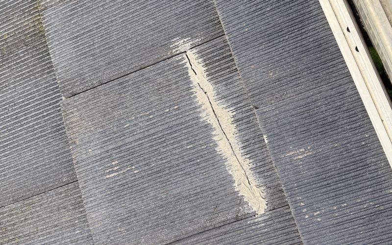 Cracked concrete roof tile sealed along the crack to stop a leak