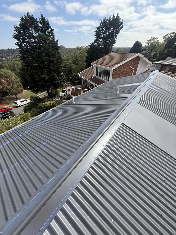 New dark corrugated metal roof with ridge capping