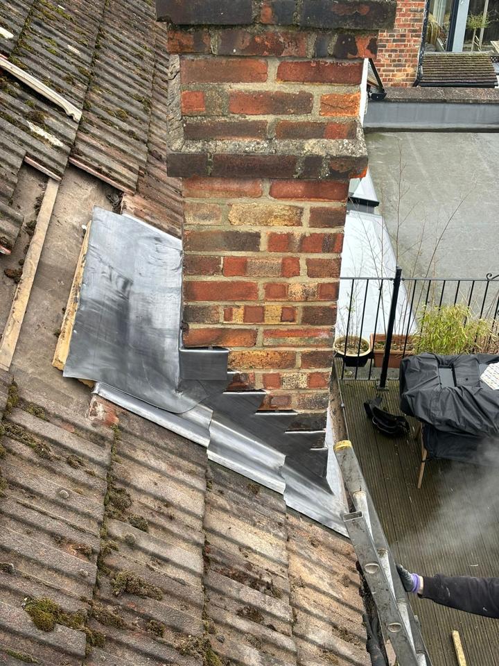 New lead flashing stepped around a brick chimney