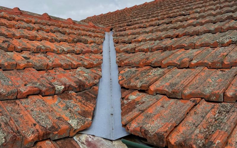 New valley flashing fitted between two terracotta tile roof sections