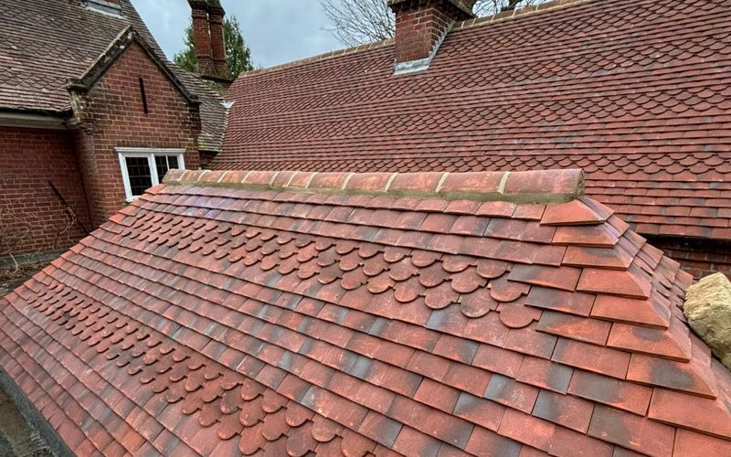 Newly laid clay tile roof with decorative scalloped tiles